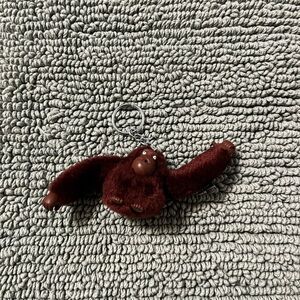 Kipling Plush Monkey Keychain 
Color: Burgundy Name: Jaden